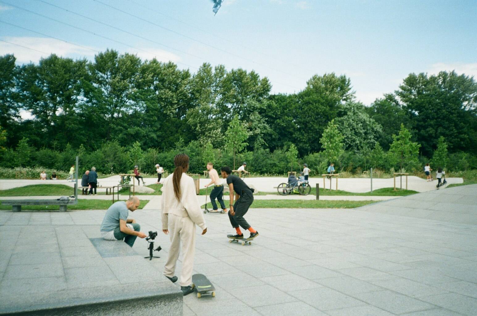 Skateboarders being filmed skating