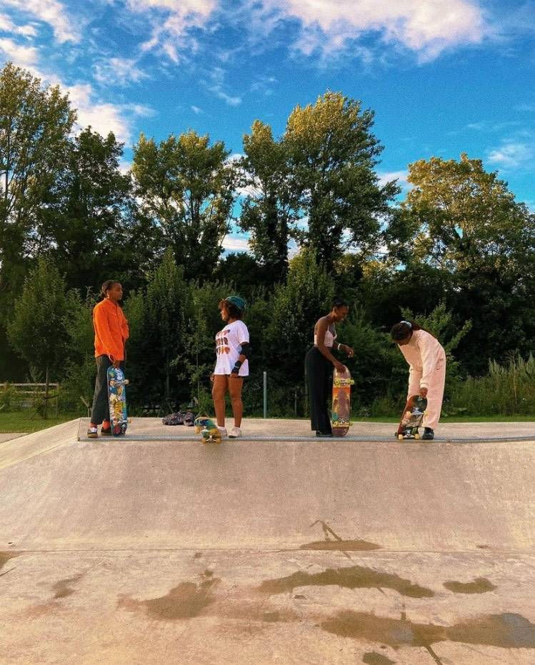 Skateboarders standing on top of a miniramp